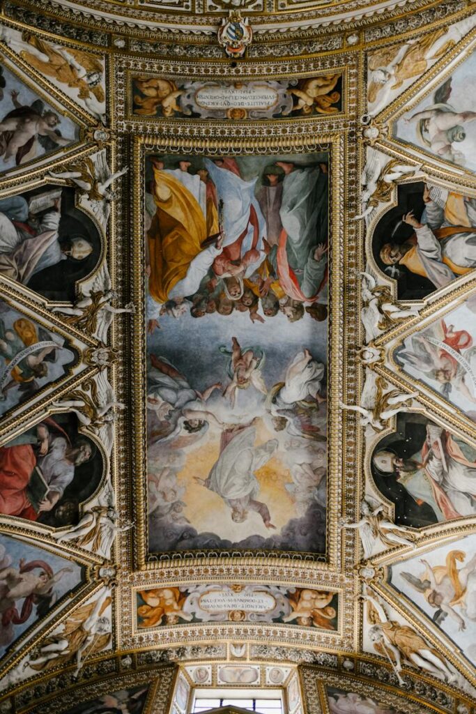 From below dome ceiling covered with majestic colorful fresco paintings in Baroque style in Catholic cathedral
