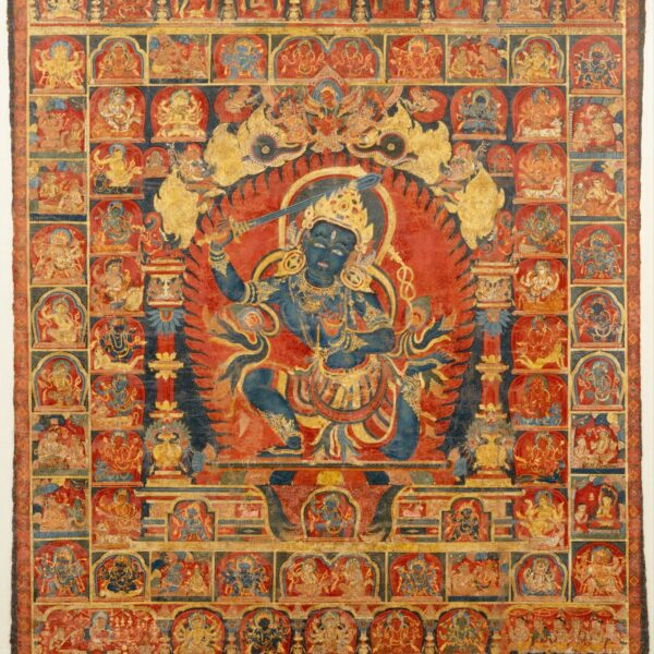 An intricate traditional Tibetan thangka painting depicting a multi-armed, blue deity surrounded by a fiery halo, with numerous smaller figures in detailed compartments around the central figure.