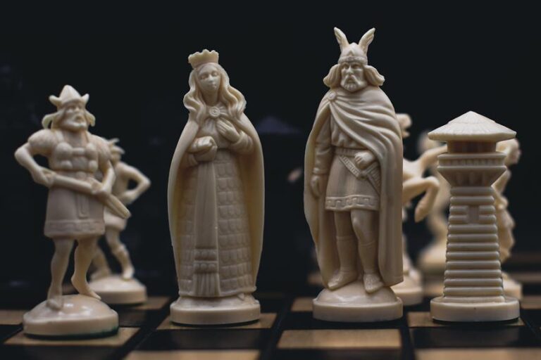A chess set with detailed ivory pieces on a wooden board, highlighting the king, queen, and other pieces against a dark background.